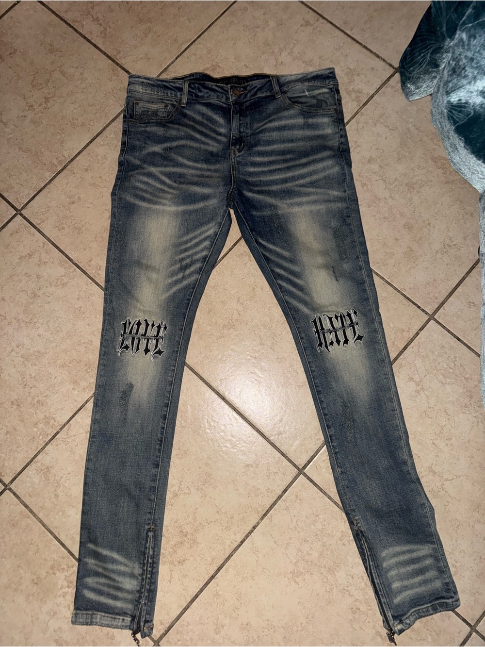 Men's god speed Blue Washed Jeans with Knee Graphic that says love hate